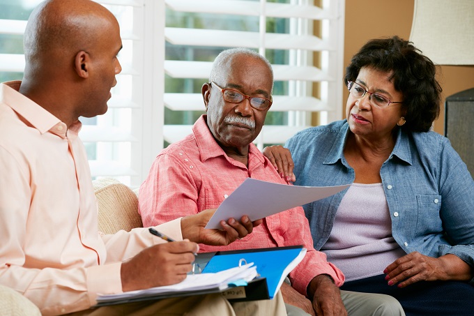 Senior couple talks with financial planning advisor or attorney to create will