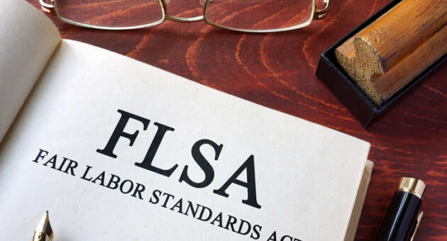 Page with FLSA fair labor standards act on a table.