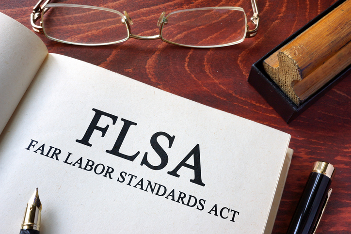 Page with FLSA fair labor standards act on a table.